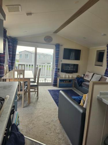a living room with a couch and a table at Haven Golden Sands Holly Drive 24 in Mablethorpe