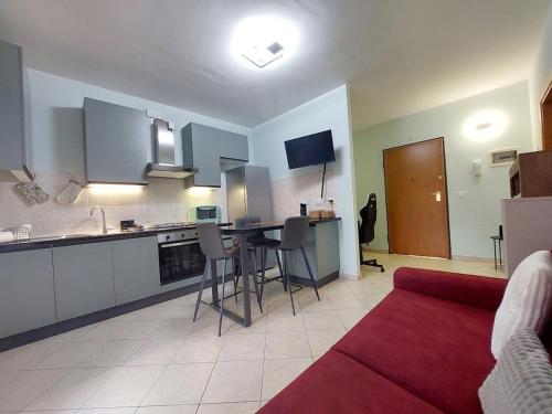 Una cocina y una sala de estar con un sofá rojo. en MAZZALI 28 a SUZZARA, en Suzzara