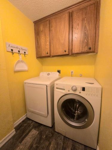 a laundry room with a washing machine and a washer at 5BR3BA Home, 2 Blocks from Beach, ADA Accessible in Galveston