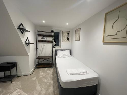 a small room with a bed and a ladder at The Diamond Retreat in Purley