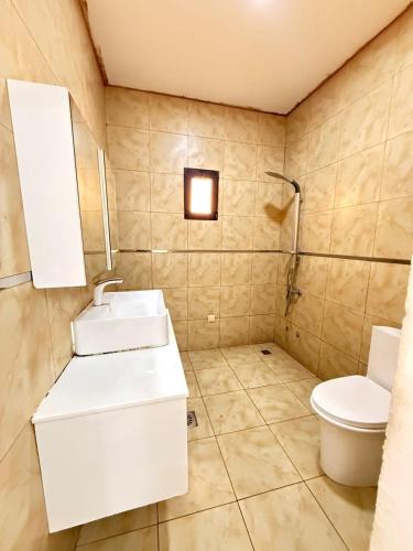 a bathroom with a sink and a toilet at Three-bedroom with Pool Two Suites in a Gated Community in Belas