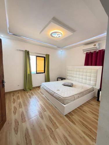 a bedroom with a large bed and a wooden floor at Three-bedroom with Pool Two Suites in a Gated Community in Belas