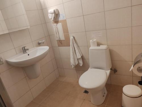 a bathroom with a toilet and a sink at Апартамент E003 в Обзор Бийч Резорт - усещането да живееш на плажа!! in Obzor