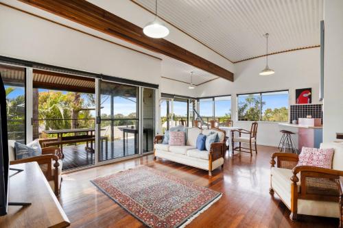 a living room with a couch and a table at Ocean View Koala Beach Retreat in Pottsville