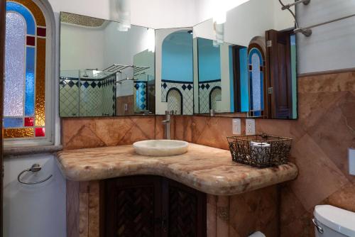 a bathroom with a sink and a mirror at Say-olita in Sayulita