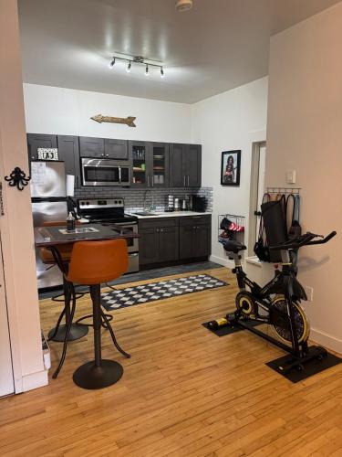 a kitchen with a table and some exercise equipment at Modern Stay in Downtown Jersey City, Close to NYC! in Jersey City