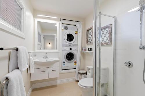 a bathroom with a sink and a washing machine at Summit Serenity in Queenstown