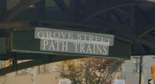 a green street sign that reads grove street path trains at Modern Stay in Downtown Jersey City, Close to NYC! in Jersey City