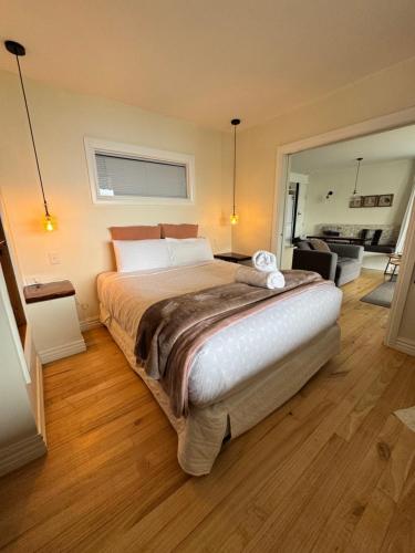 a bedroom with a large bed and a living room at Summit Serenity in Queenstown