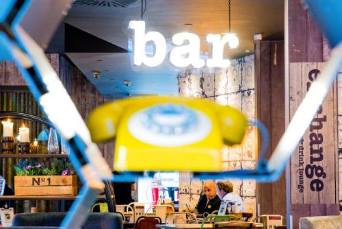 two people sitting at a table in a restaurant at Novotel Manchester Centre in Manchester