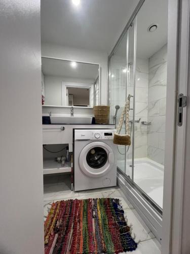 a bathroom with a washing machine and a sink at PANORAMA In Orbi complex central Hotel in Batumi
