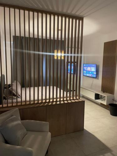 a living room with a bed and a tv at Nordico II in La Plata