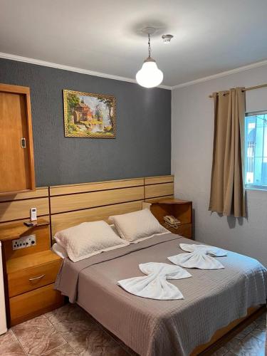 a bedroom with a large bed with white towels on it at Hotel Mooca in São Paulo