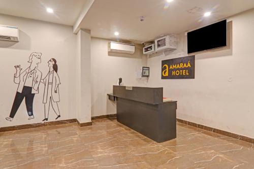 a hotel lobby with a reception desk and a painting on the wall at Super Townhouse Amaraa Hotel Near Phoenix Palassio in Lucknow