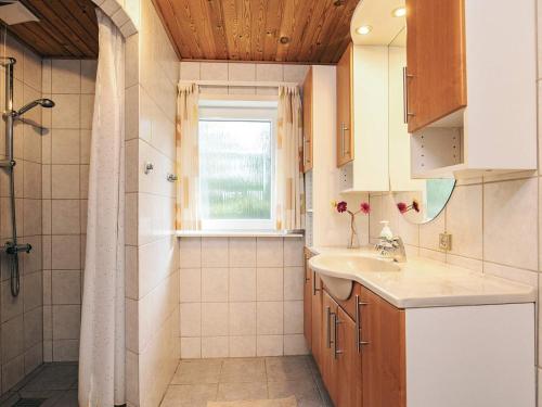 a bathroom with a sink and a shower at 4 star holiday home in Hals in Hals
