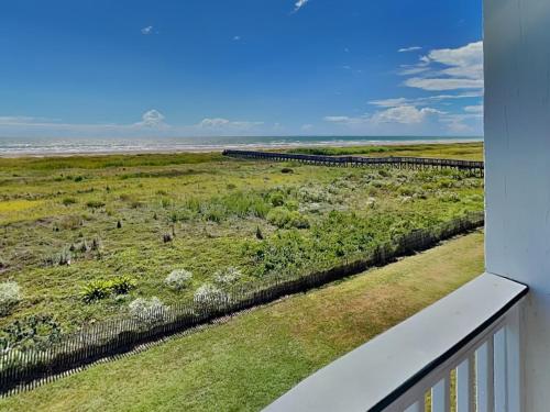 a view of a field from a balcony at So Serene in Galveston