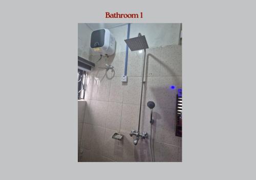 a bathroom with a shower with a shower head at PRAISE PLACE - Heritage 7 Apartments in Ijebu Ode