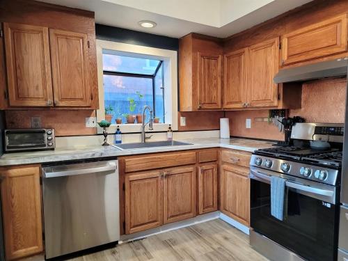 a kitchen with wooden cabinets and a sink and a stove at Stag & Sparrow in Salem