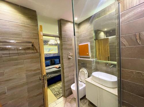 a bathroom with a toilet and a sink at IBIZA LAGoS in Lagos