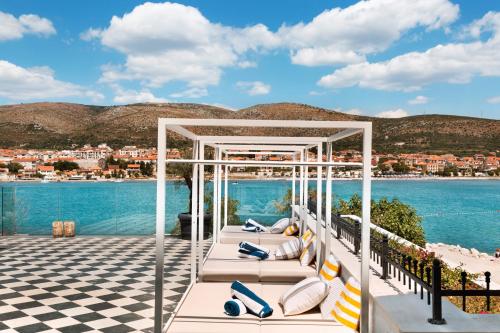a gazebo on a deck with the water at Hotel Brown Beach House & Spa in Trogir