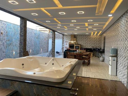 a large bath tub in a room with a dining room at Casa por temporada in Barreirinhas