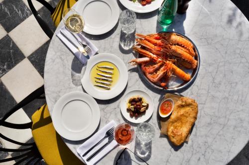 a table with plates of food and seafood on it at Hotel Brown Beach House & Spa in Trogir