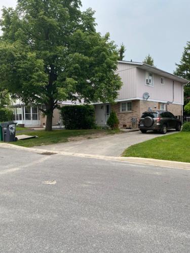 a house with a car parked in the driveway at Comfy Private Room in Brampton