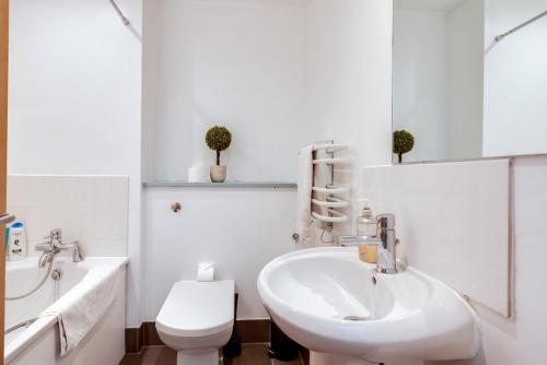 a white bathroom with a sink and a toilet at Elegant Oxford Flat - Central Spacious Comfortable in Oxford
