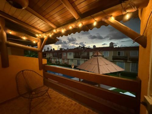 a balcony with a view of a building with lights at Casa Morroken Ixtapa con Alberca in Ixtapa