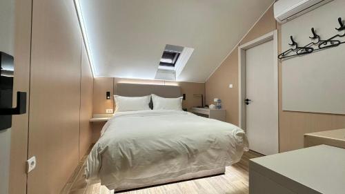 a bedroom with a large bed in a room at Kimmiy in Beograd