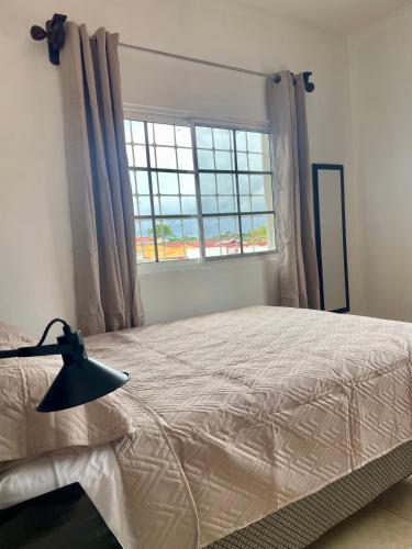 a bedroom with a bed and a window at Trébol House Hostel in La Ceiba