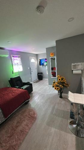 a bedroom with a bed and a couch and a table at Unit #10 Private Studio in Hempstead