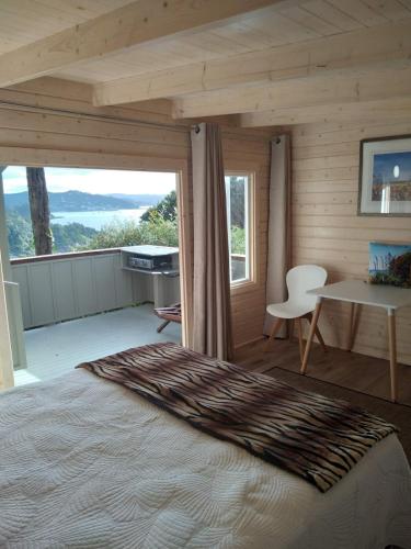a bedroom with a bed and a table and window at The Tawnys Gatehouse in Russell
