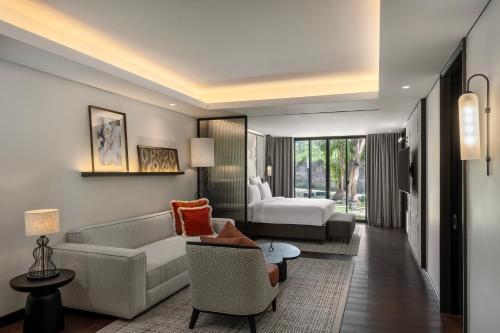 a living room with a couch and a chair at Pullman Bali Legian Beach in Legian