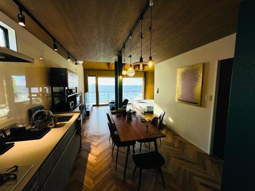 a kitchen and dining room with a table in it at AWAJI OCEAN BASE west coast in Tsushi