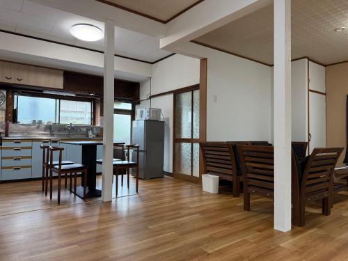 a kitchen and dining room with a table and chairs at Ku-chan House in Tateyama