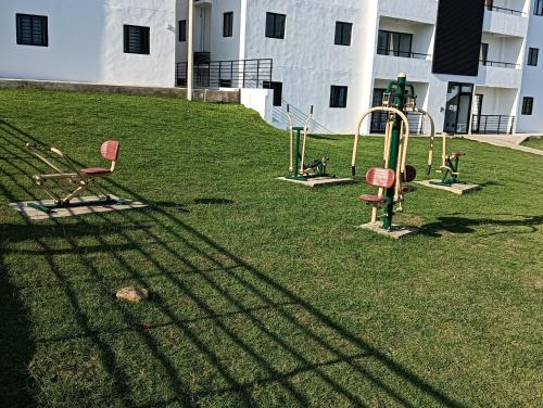 a playground in a yard with a building at santiago de los caballeros hipanoamericana in Santiago de los Caballeros