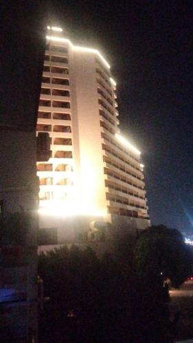 a tall building with lights on top of it at night at Host-Gram Hotel & Suites Downtown in Cairo