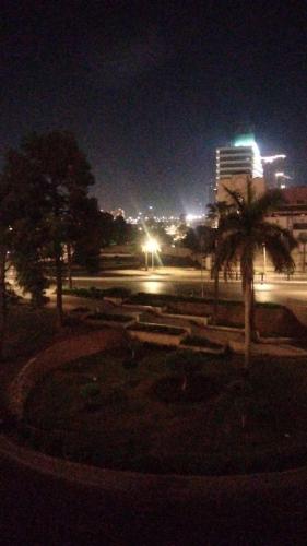 a park at night with a palm tree and a building at Host-Gram Hotel & Suites Downtown in Cairo