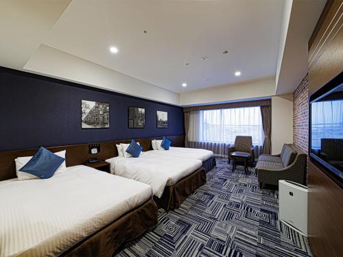 a hotel room with two beds and a television at The Park Front Hotel at Universal Studios Japan in Osaka