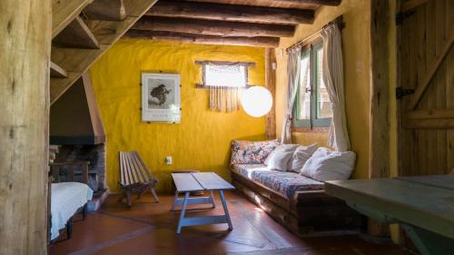 a living room with a couch and a table at Posada Hale Nalu in La Paloma