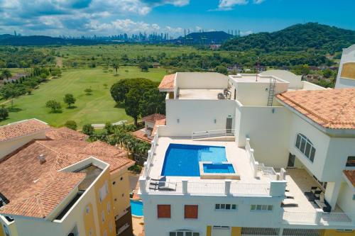 an aerial view of a house with a swimming pool at Canal-Front Luxury 3BR City & Golf Views Private in Cocolí