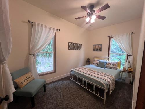 a bedroom with a bed and a ceiling fan at Relaxing Townhouse Downtown Dubuque in Dubuque