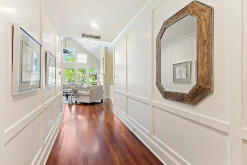 a hallway with white walls and a mirror on the wall at BW3038: 3038 Baywood Drive in Seabrook Island