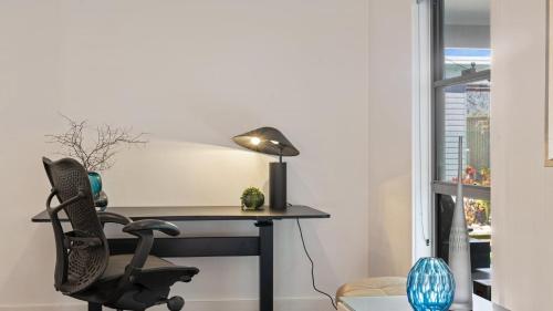 a desk in a room with a chair and a lamp at The Oasis-Shelly Beach-Private Pool-Golf in Shelly Beach