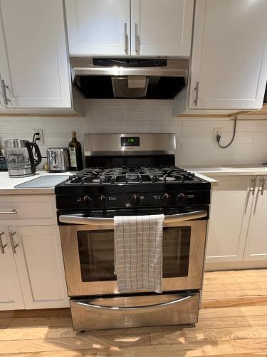 a kitchen with a stove with a towel on it at Studio Apartment with Garden Jersey City in Jersey City