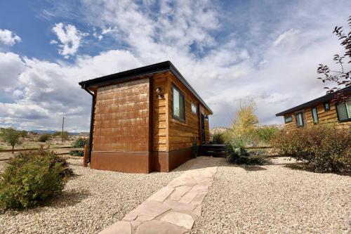 a small wooden cabin in the middle of a field at Escalante Escapes Holly Hock- King Escape in Escalante