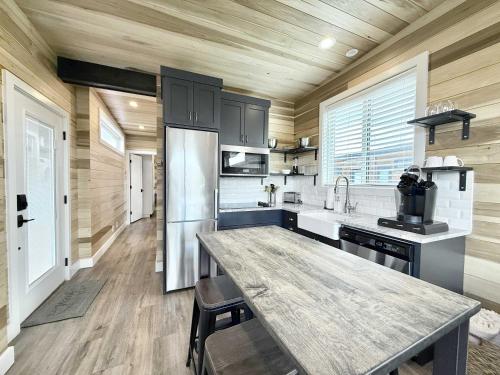 a kitchen with a wooden ceiling and a large counter top at Escalante Escapes Moon Lily- Bunk Escape in Escalante
