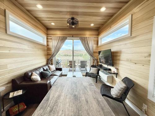 a living room with a couch and a tv at Escalante Escapes Moon Lily- Bunk Escape in Escalante
