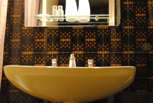 a white sink in a bathroom with a mirror at Hotel Miradouro in Porto